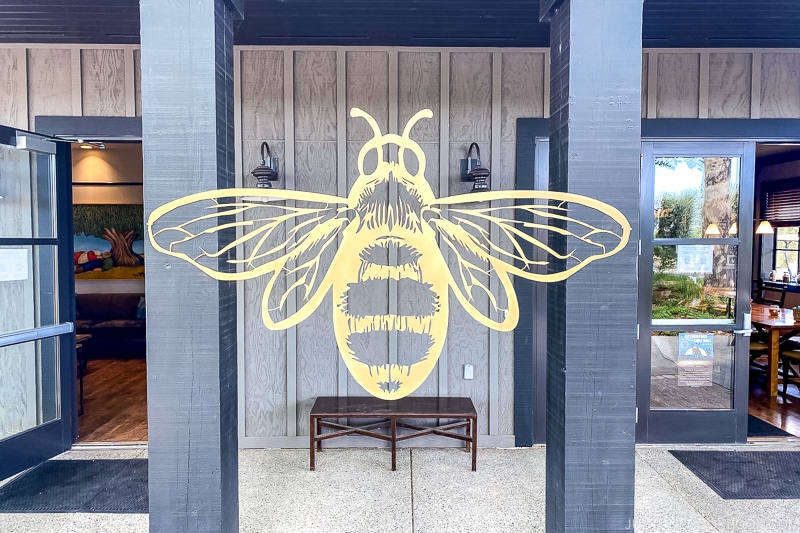 a bee motif on two wood beams