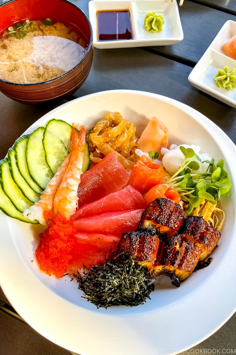 chirashi sushi with miso soup on a table
