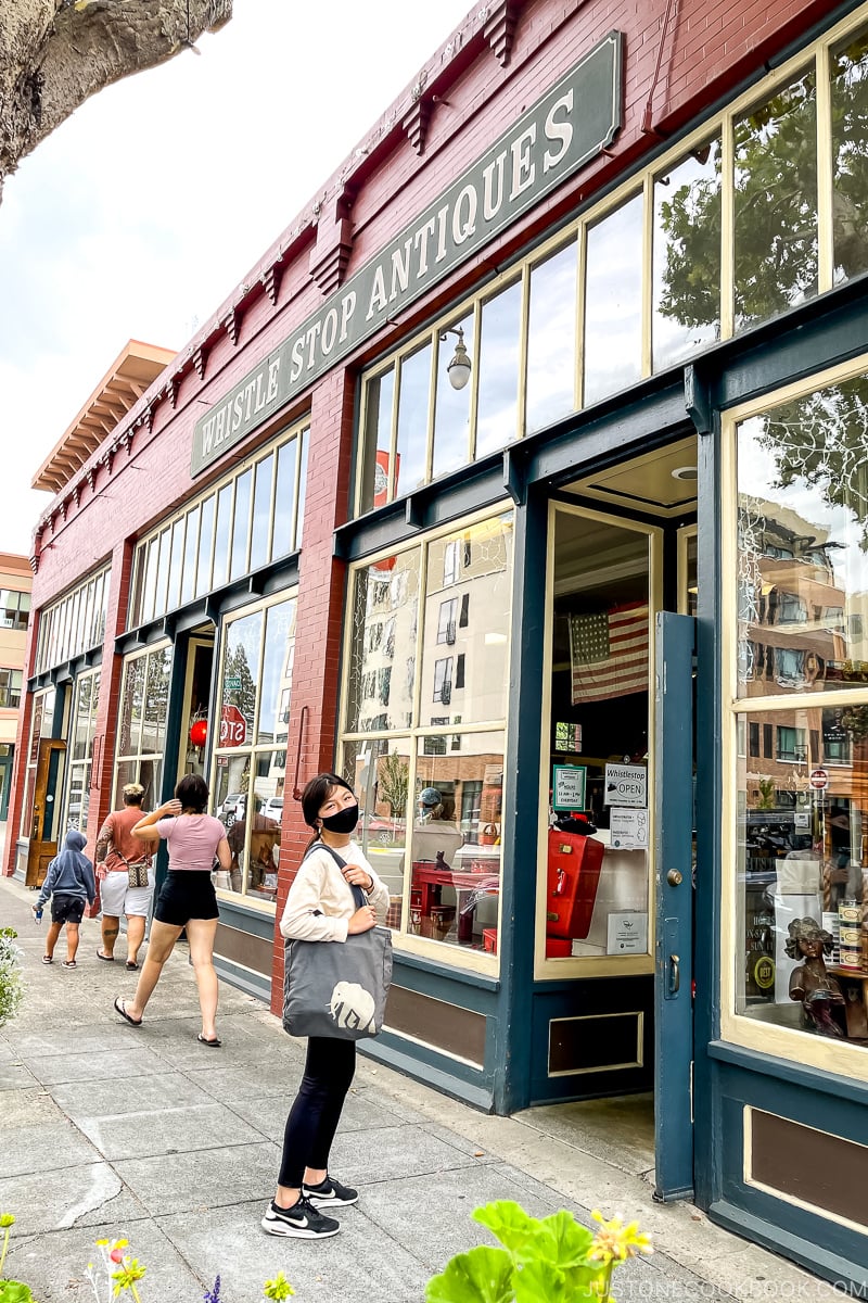 girl in front of antique shop