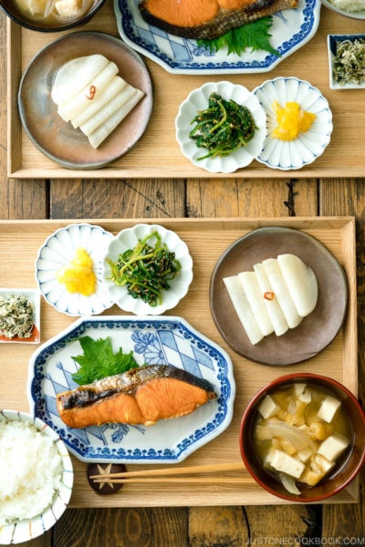 A classic Japanese style meal consists of multiple dishes on a wooden tray.