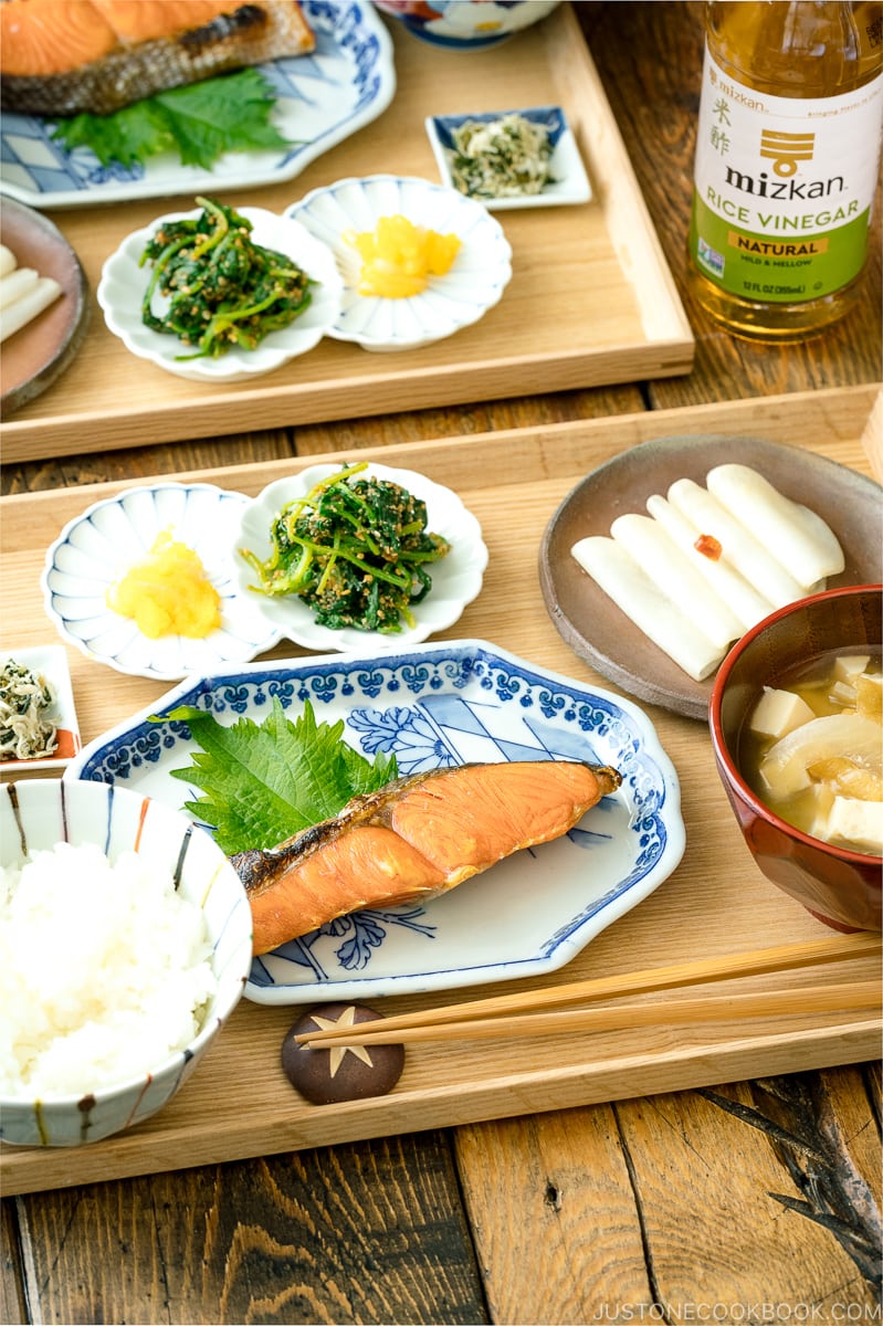 A classic Japanese style meal consists of multiple dishes on a wooden tray.