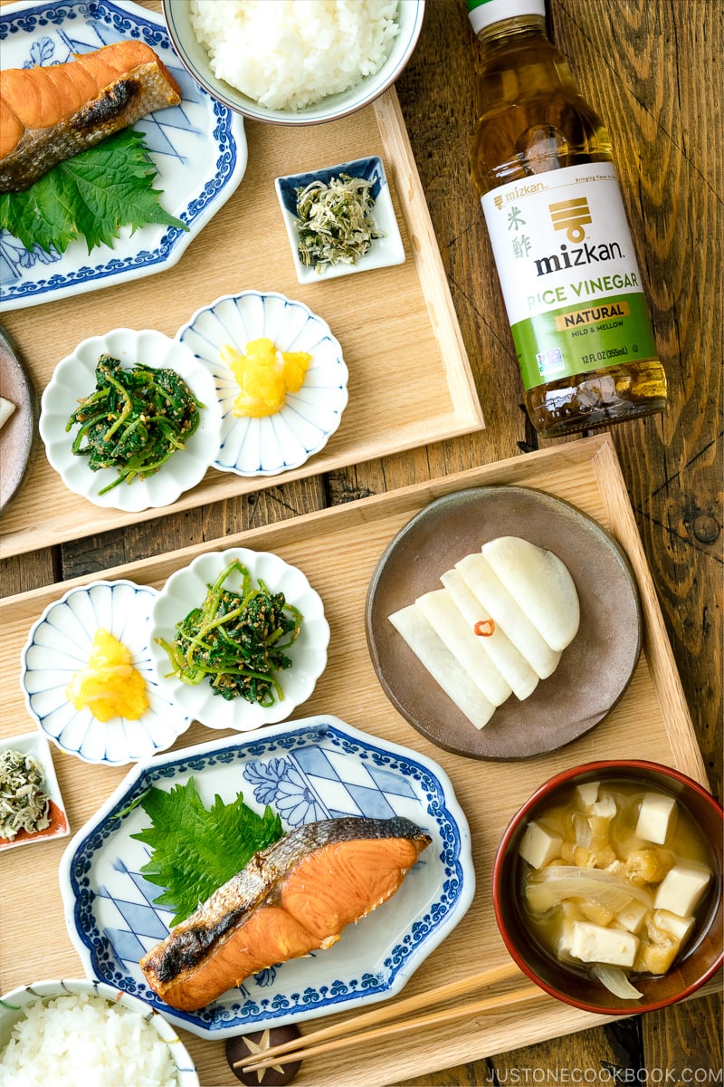 A classic Japanese style meal consists of multiple dishes on a wooden tray.