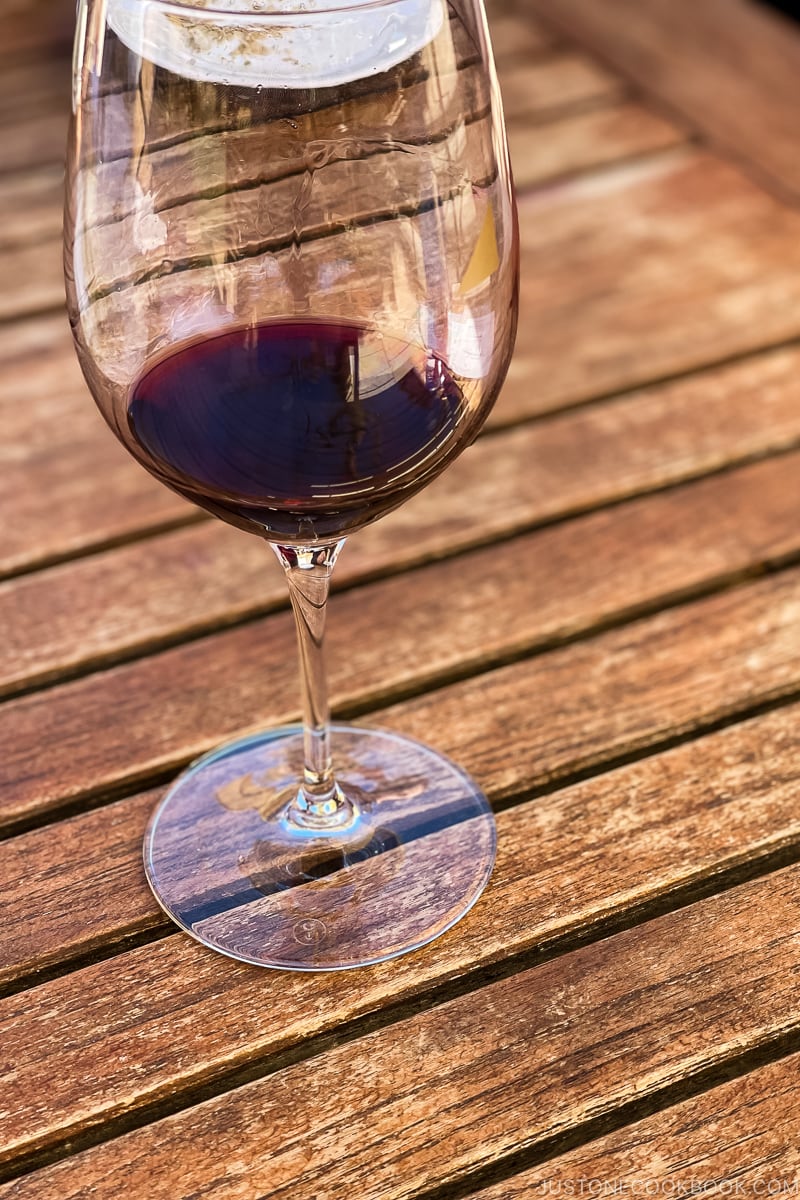 a glass of wine on wood table