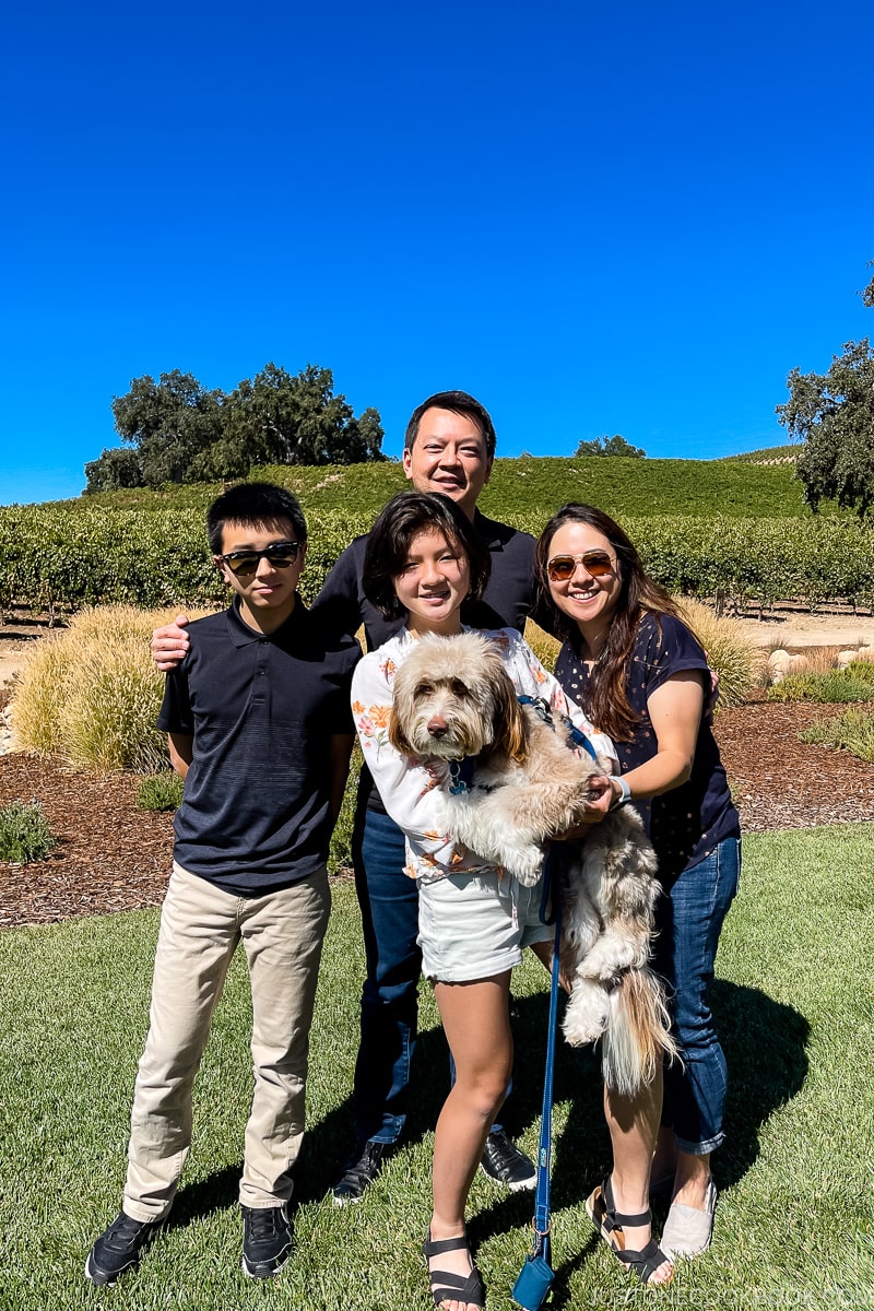 a family in front of vineyard