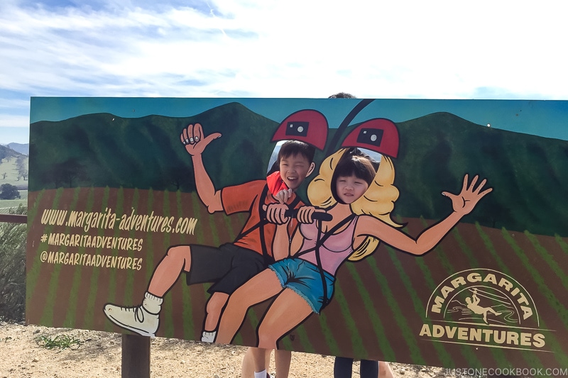 two children behind Margarita Adventures cutout