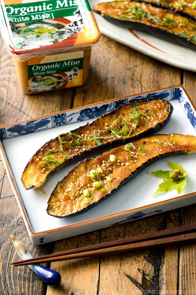 A square plate containing Miso Glazed Eggplant garnished with yuzu kosho.