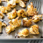 A baking sheet pan containing Roasted Miso Garlic Cauliflower.