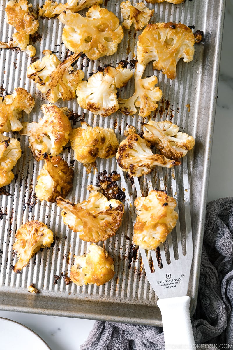 A baking sheet pan containing Roasted Miso Garlic Cauliflower.