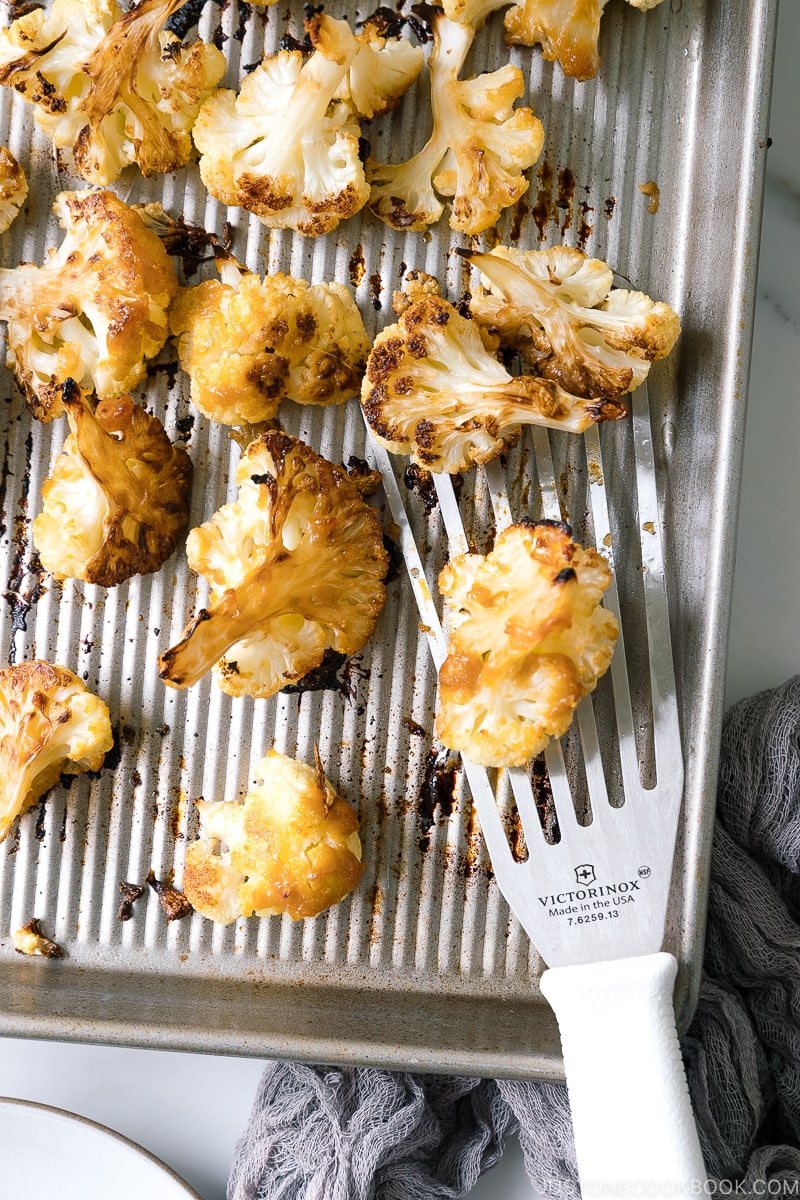 A baking sheet pan containing Roasted Miso Garlic Cauliflower.