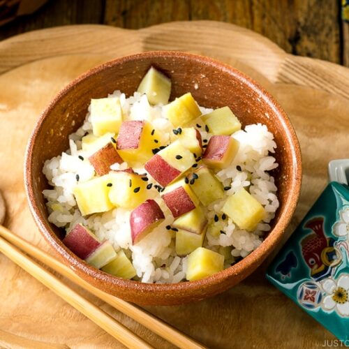 A rice bowl containing Sweet Potato Rice (Satsumaimo Gohan) sprinkled with gomashio (salt & black sesame seeds).