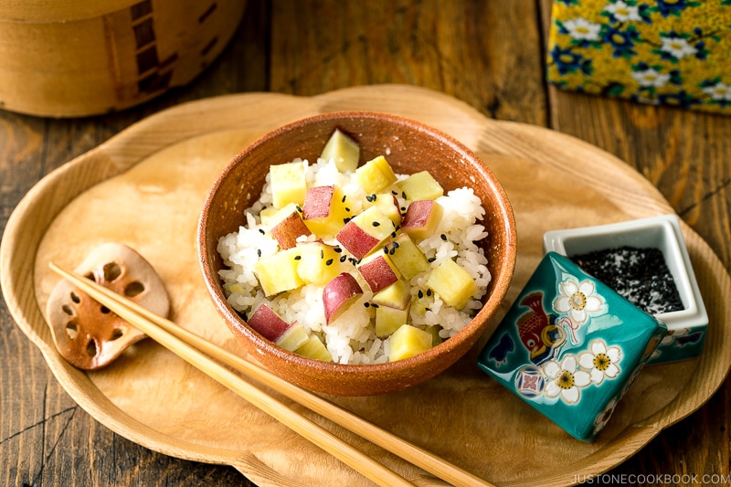 A rice bowl containing Sweet Potato Rice (Satsumaimo Gohan) sprinkled with gomashio (salt & black sesame seeds).