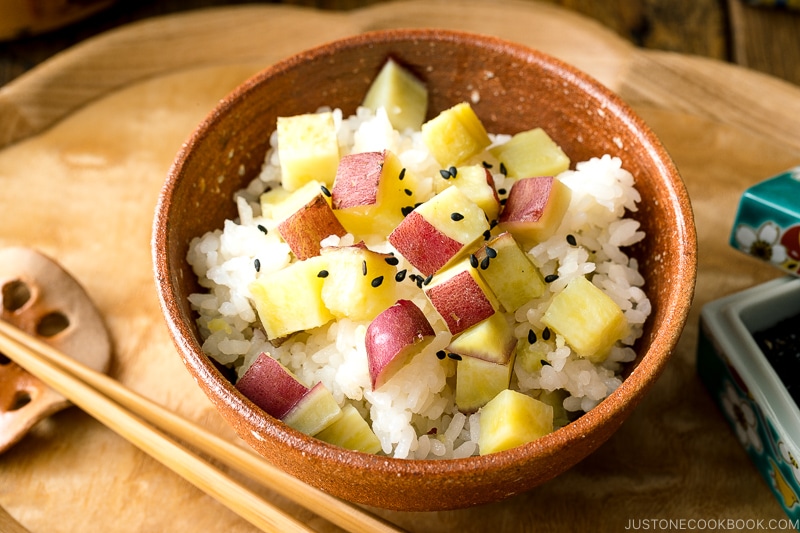 A rice bowl containing Sweet Potato Rice (Satsumaimo Gohan) sprinkled with gomashio (salt & black sesame seeds).