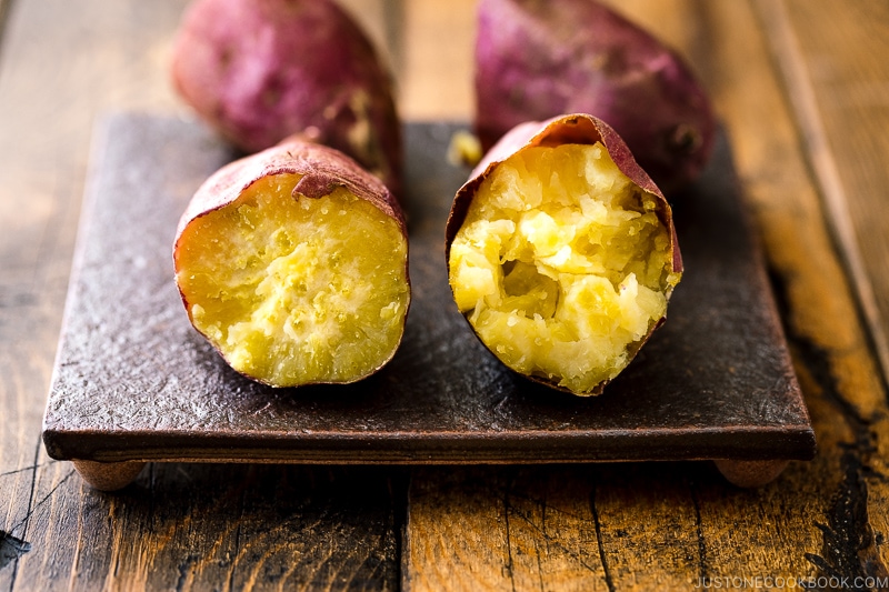 Two types of baked sweet potatoes on a plate.