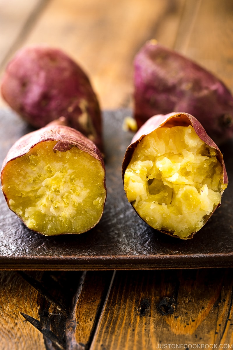 Two types of baked sweet potatoes on a plate.