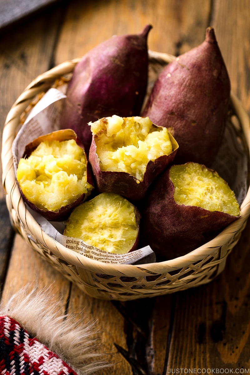 Japanese bamboo basket containing baked sweet potatoes.