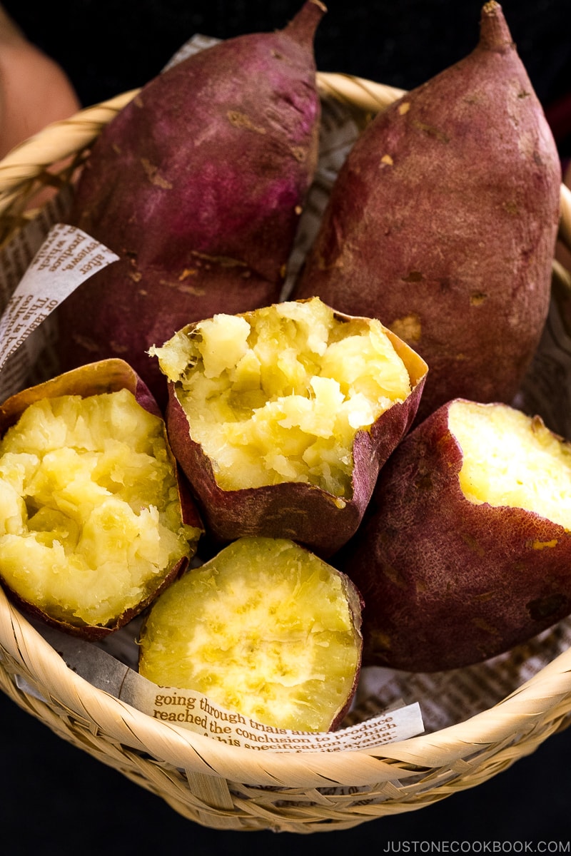 Japanese bamboo basket containing baked sweet potatoes.