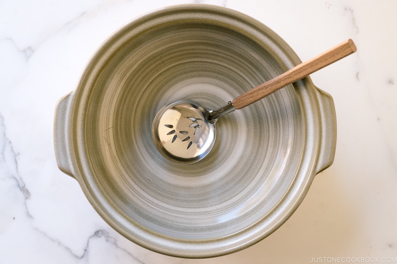 serving ladle for hotpot inside a Japanese earthenware