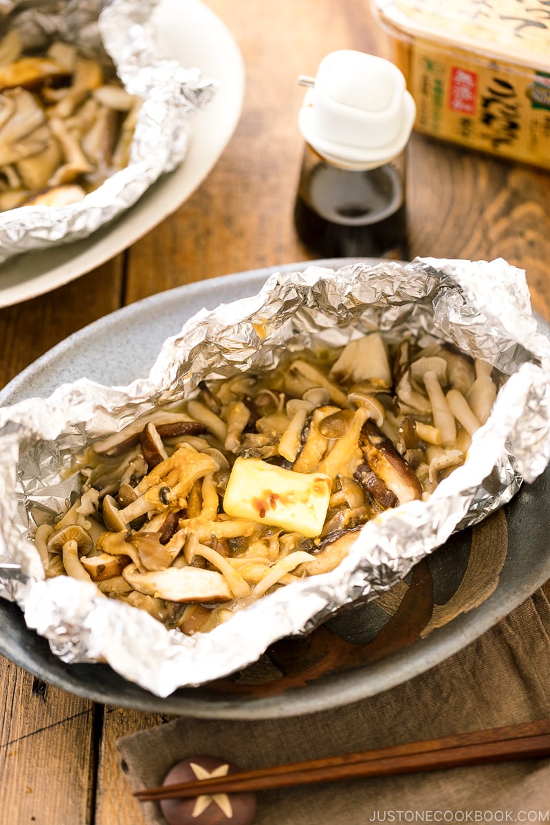 Assortment of mushrooms are wrapped and cooked in foil with miso and butter.