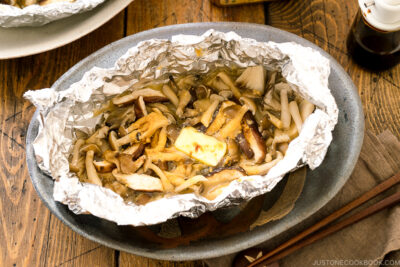 Assortment of mushrooms are wrapped and cooked in foil with miso and butter.