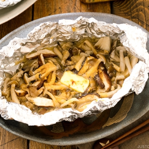 Assortment of mushrooms are wrapped and cooked in foil with miso and butter.