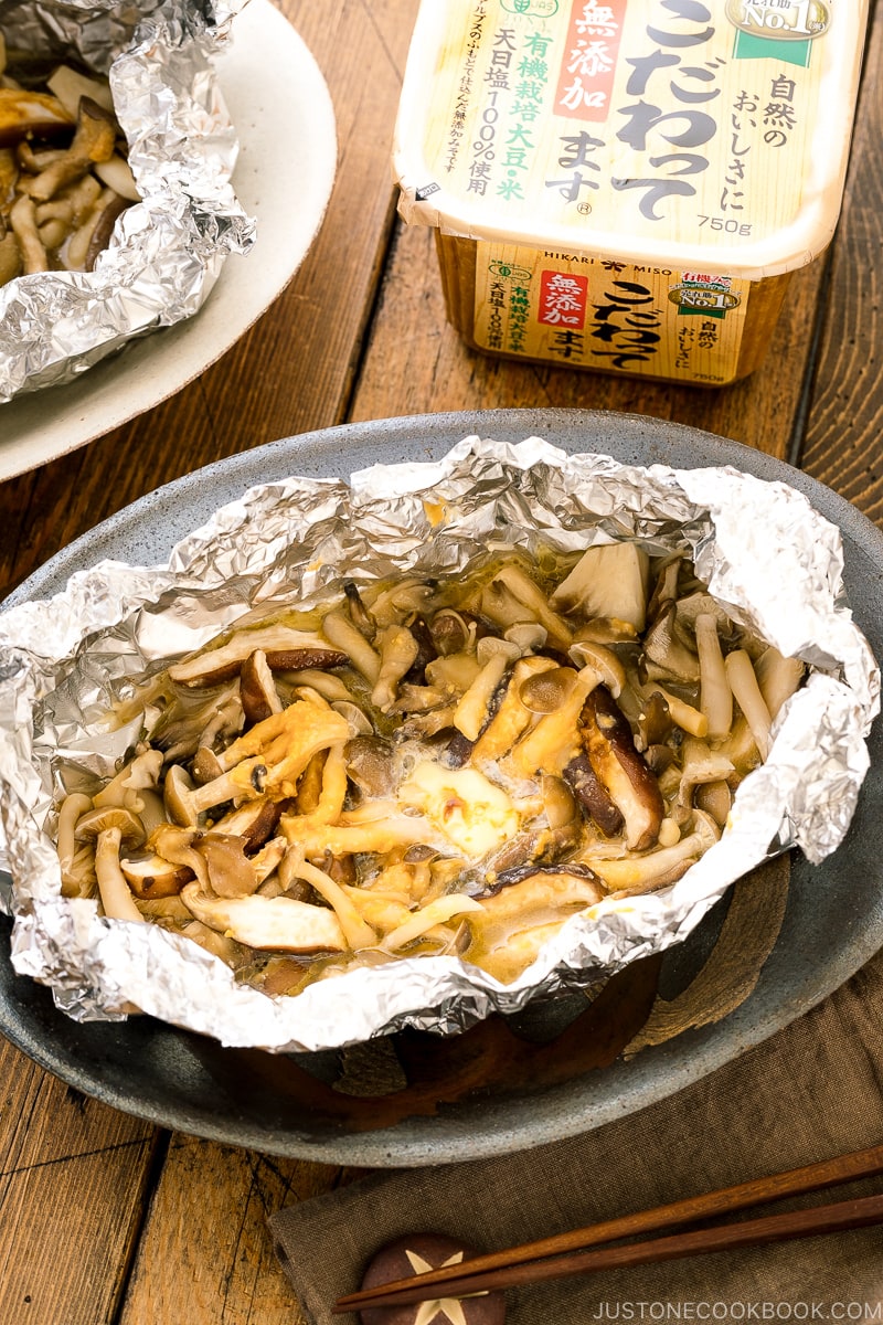 Assortment of mushrooms are wrapped and cooked in foil with miso and butter.
