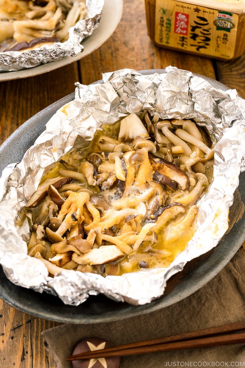 Assortment of mushrooms are wrapped and cooked in foil with miso and butter.