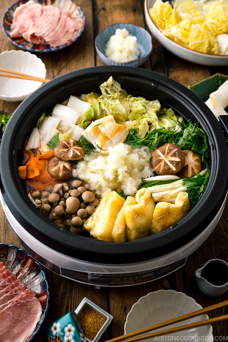 An electric hot pot containing Mizore Nabe, a Japanese hot pot with grated daikon.