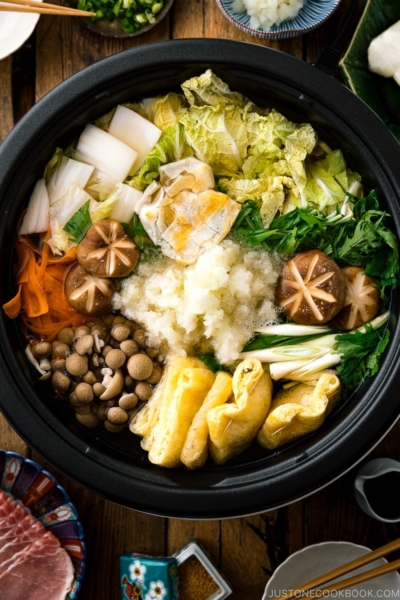 An electric hot pot containing Mizore Nabe, a Japanese hot pot with grated daikon.