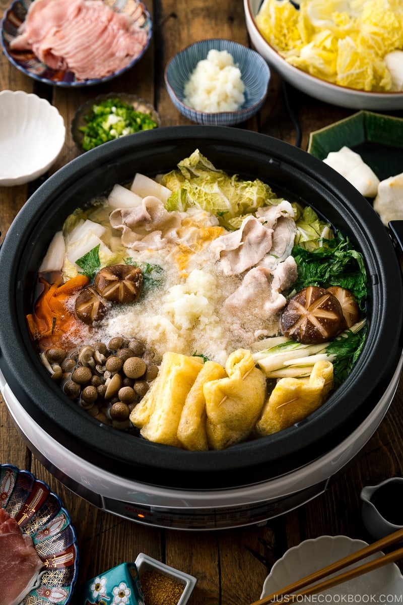 An electric hot pot containing Mizore Nabe, a Japanese hot pot with grated daikon.