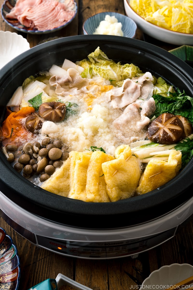 An electric hot pot containing Mizore Nabe, a Japanese hot pot with grated daikon.