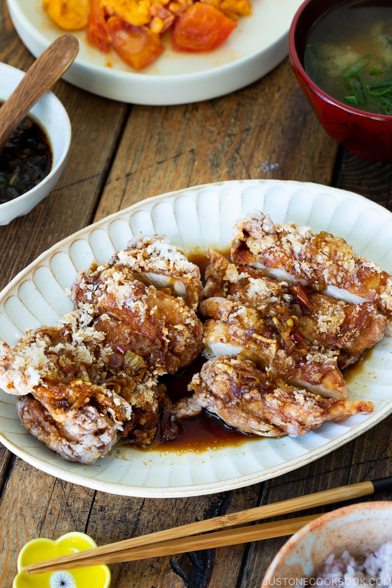 A oval plate containing Fried Chicken with Scallion Soy Sauce.