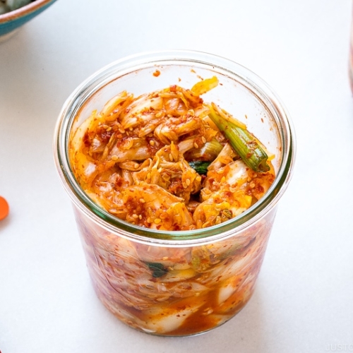 Weck jars containing fresh kimchi.