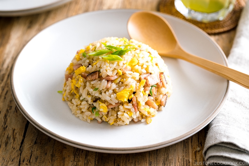 A white ceramic plate containing Japanese fried rice (Yakimeshi).