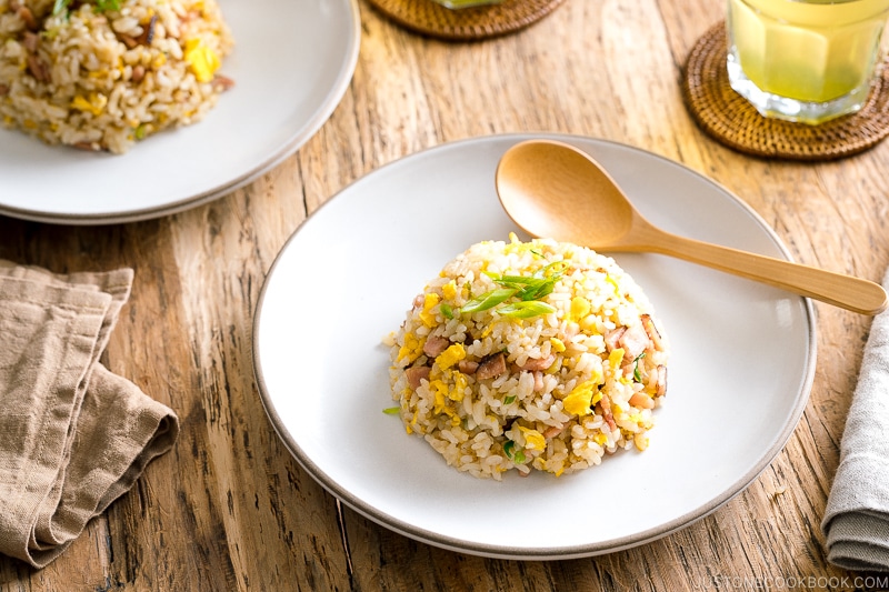 A white ceramic plate containing Japanese fried rice (Yakimeshi).