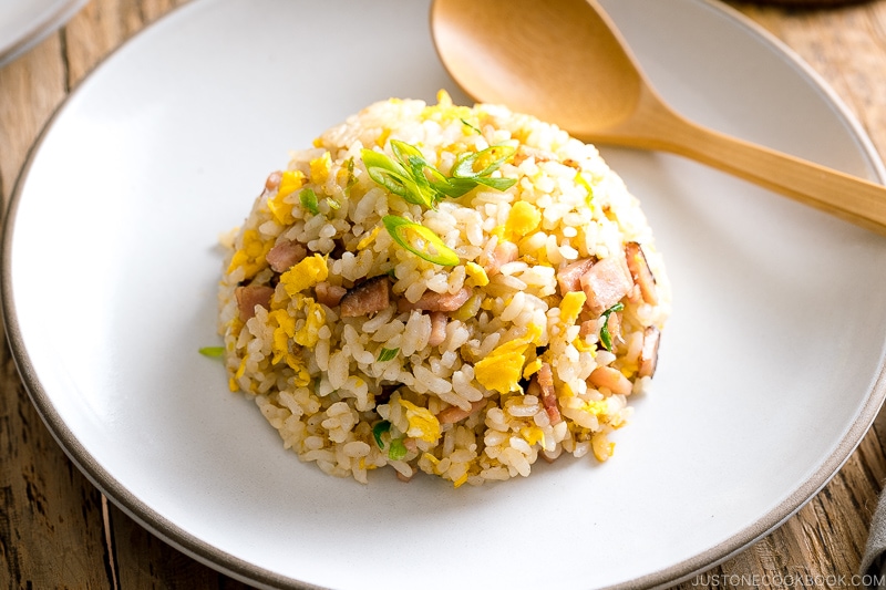 A white ceramic plate containing Japanese fried rice (Yakimeshi).