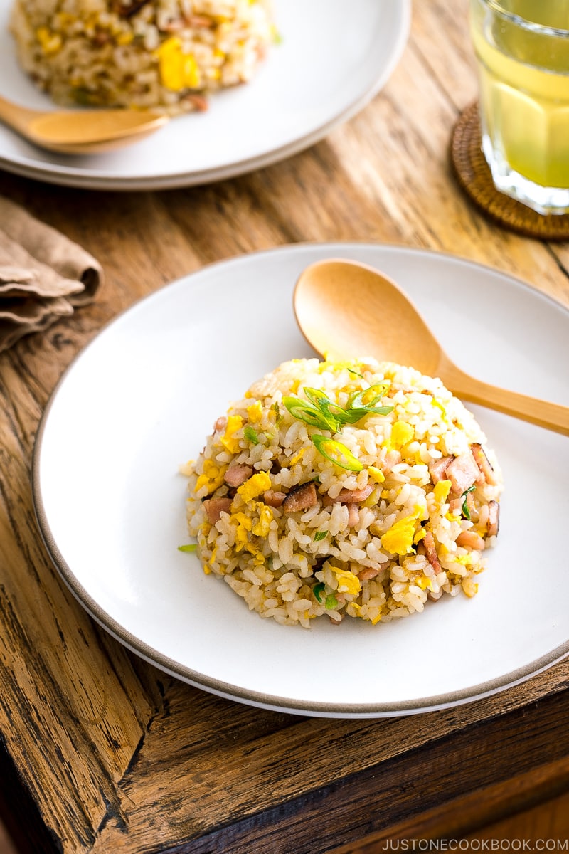 A white ceramic plate containing Japanese fried rice (Yakimeshi).