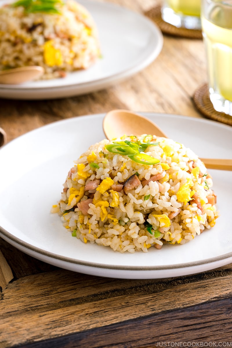 A white ceramic plate containing Japanese fried rice (Yakimeshi).