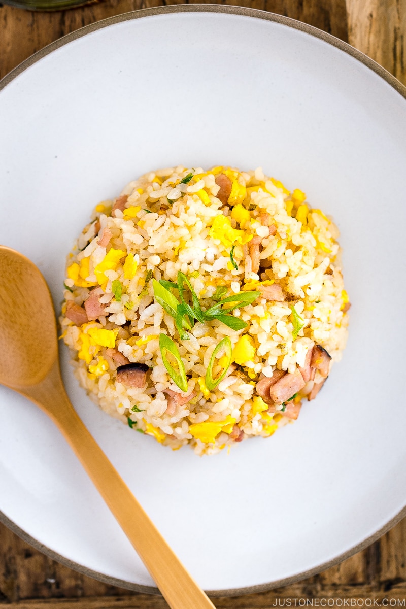 A white ceramic plate containing Japanese fried rice (Yakimeshi).