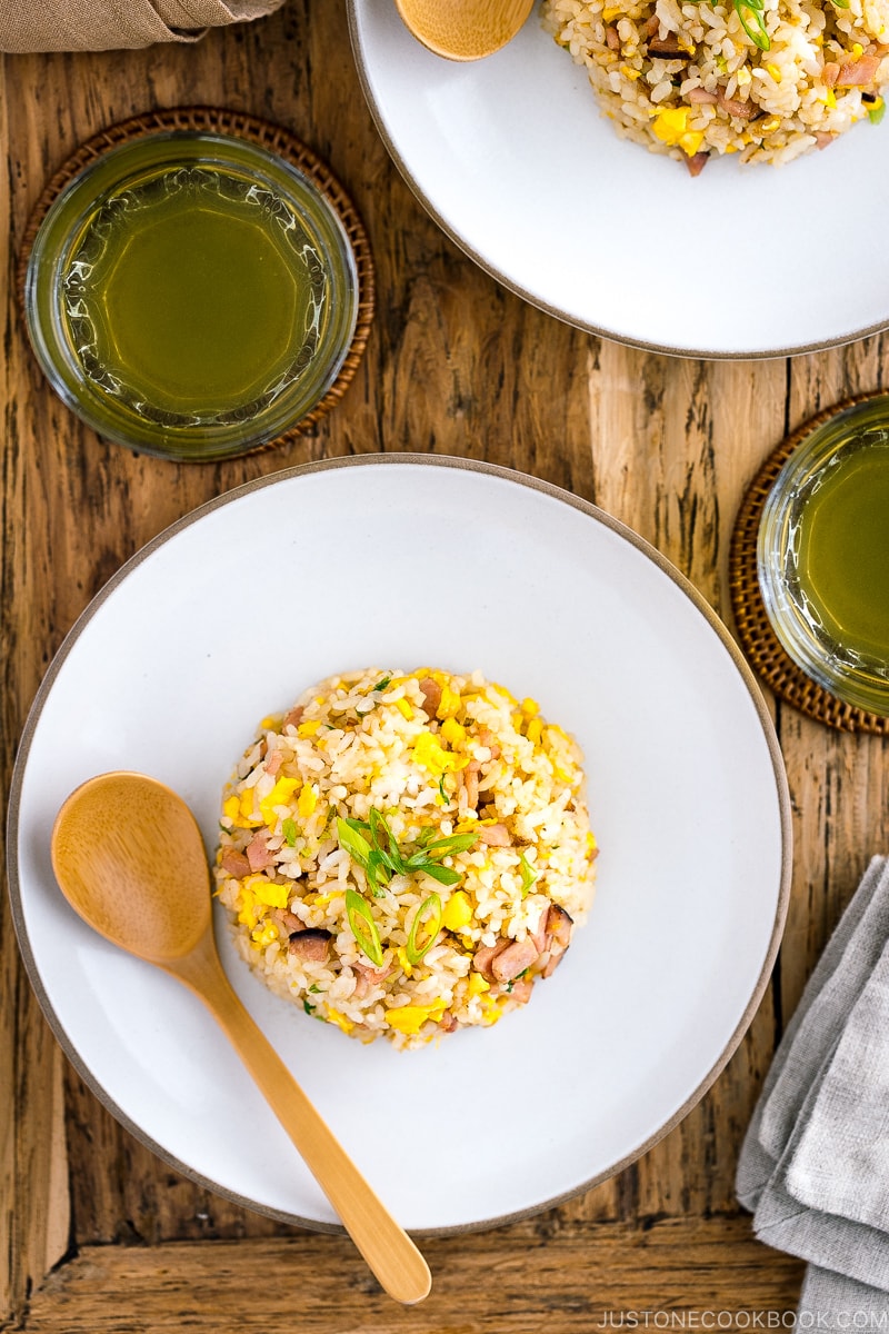 A white ceramic plate containing Japanese fried rice (Yakimeshi).