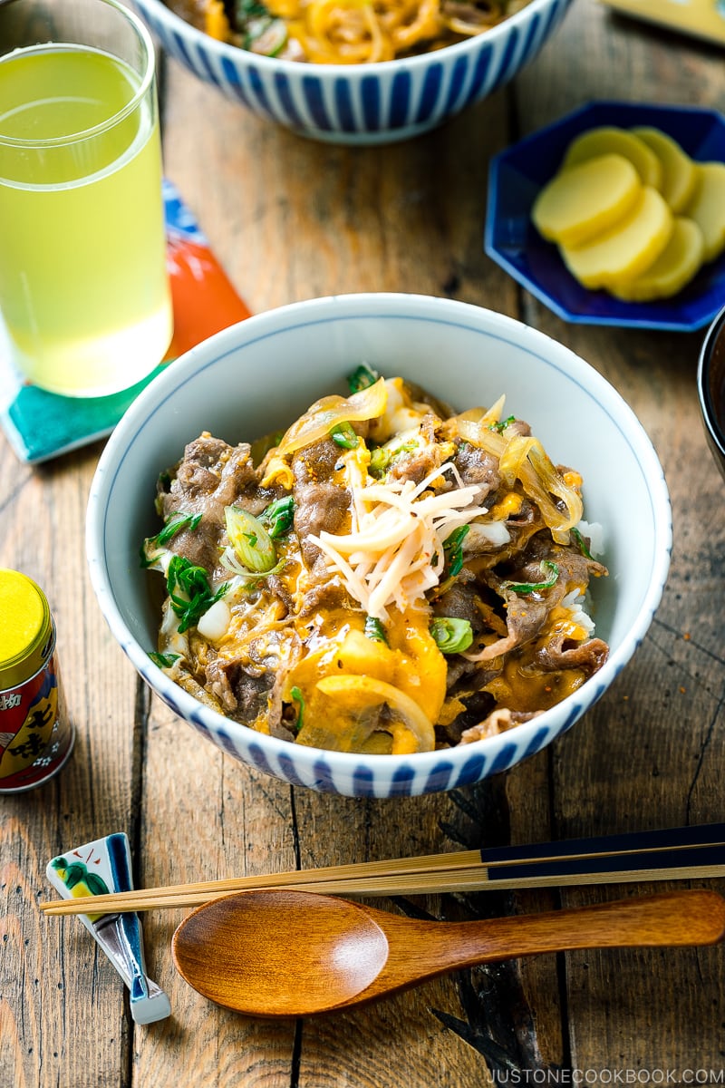 A Japanese donburi bowl containing Tanindon, which is simmered beef and egg over steamed rice.