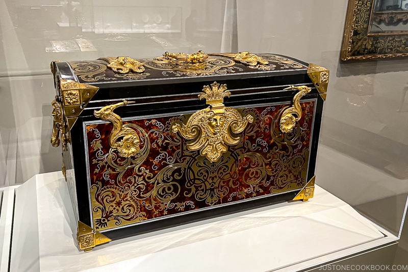 an intricate chest on display at a gallery room at The Art Institute of Chicago