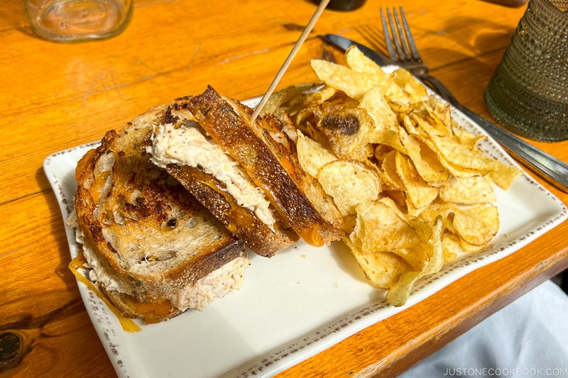 Tuna Salad Melt with chips on a white plate