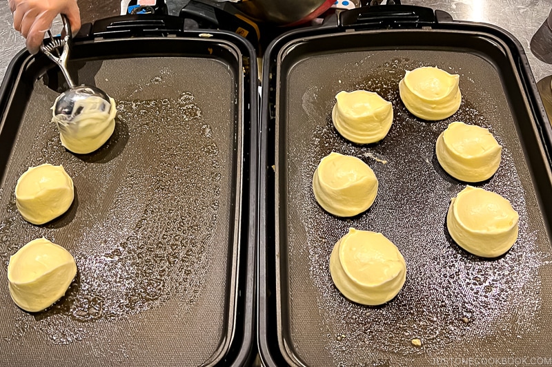 souffle pancake batter cooking on hot plates