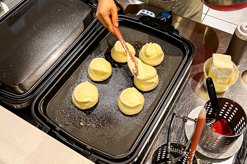 souffle pancake batter cooking on hot plates