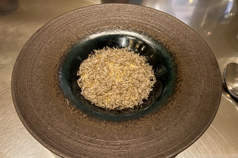 grated osetra caviar on a dark plate