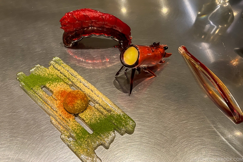 foie gras and shrimp served on a shrimp shaped dinnerware