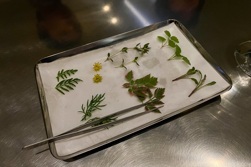 small pieces of herbs on white paper towel