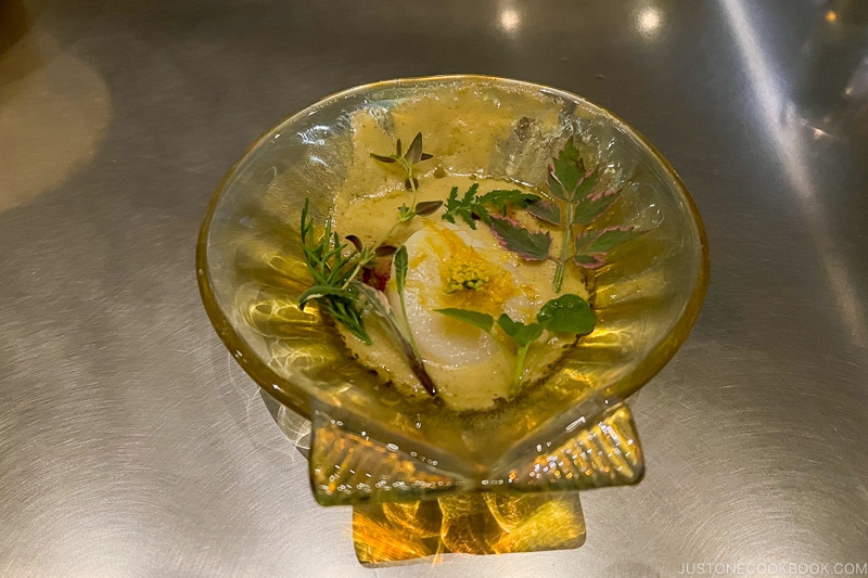 scallop on a glass shell shaped dish