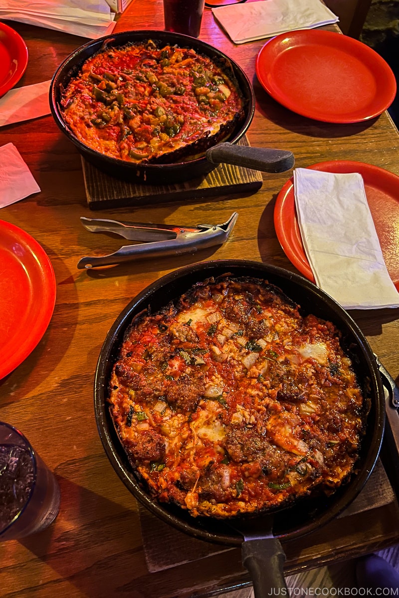 2 pizzas on the table at Pequod's Pizza