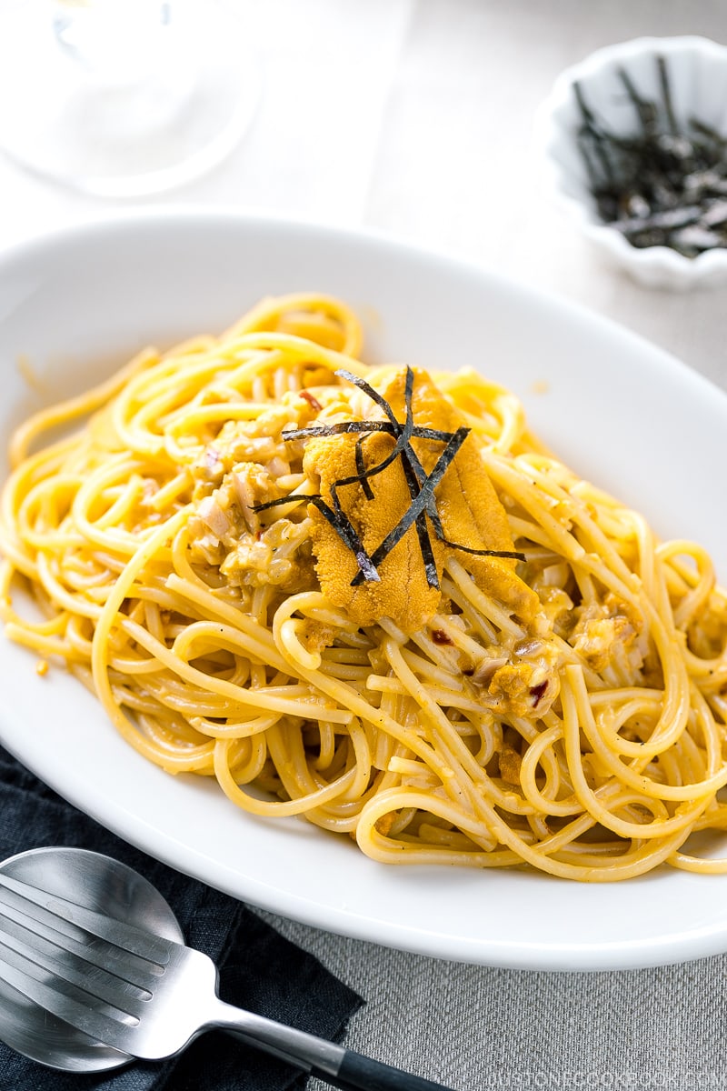 A white oval plate containing Uni Pasta (Japanese sea urchin pastsa).